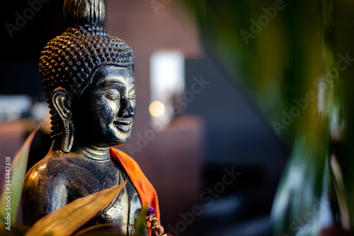 buddha statue in interior garden at tropical bar in thailand photo