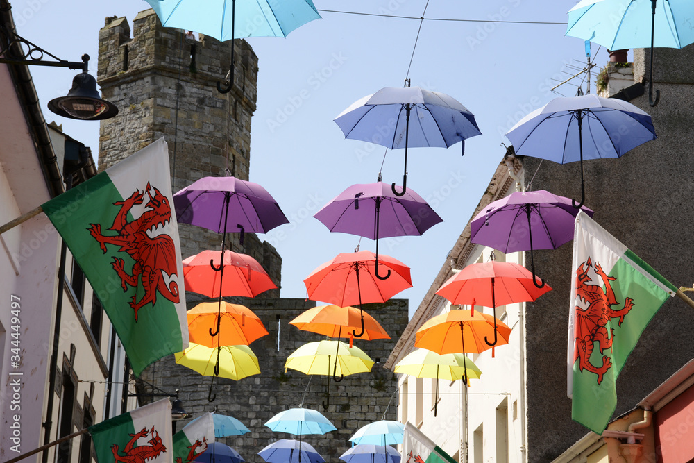Photos Coloured umbrellas and Welsh flags fly in the Royal town of Caernarfon in North