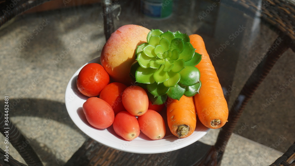 Tomatoes, carrots on the table glass