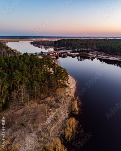 Areal drone view of small river near pine tree forest. © Artūrs Stiebriņš