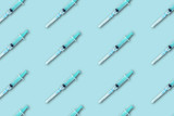 medical syringe pattern on blue background