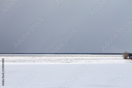 white snow and gray sky merge on the horizon © eevlada