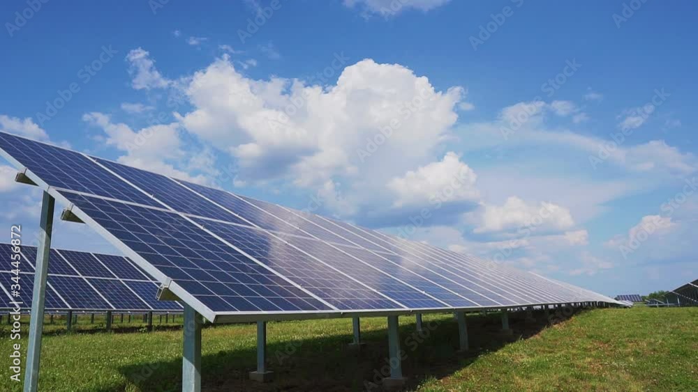 Solar power station with photo galvanic panels on a background of blue sky with clouds. Solar power station with photo galvanic panels on a background of blue sky with clouds.