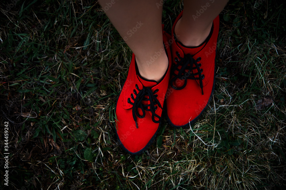 
bright red sneakers on the grass