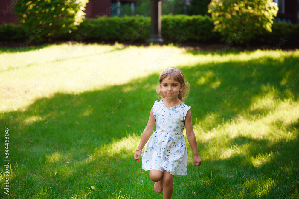Sweet little girl outdoors with curly hair in the wind. Sweet little girl outdoors with curly hair in the wind.