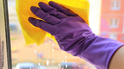 Wallpaper Mural hand in a rubber glove with a napkin washes a window in a house Torontodigital.ca