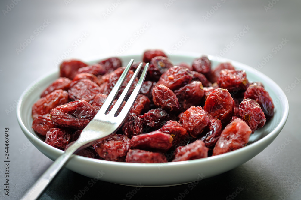Closeup view of a White plate Full of Dried Cranberries Closeup view of a White plate Full of Dried Cranberries