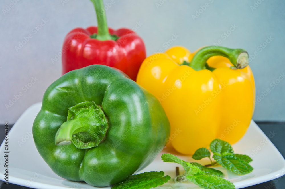 Beautiful sweet peppers and leaves close up Beautiful sweet peppers and leaves close up