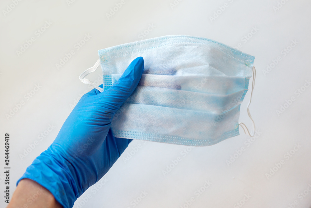 close-up of doctor's hand with a medical face mask for protection against infection close-up of doctor's hand with a medical face mask for protection against infection