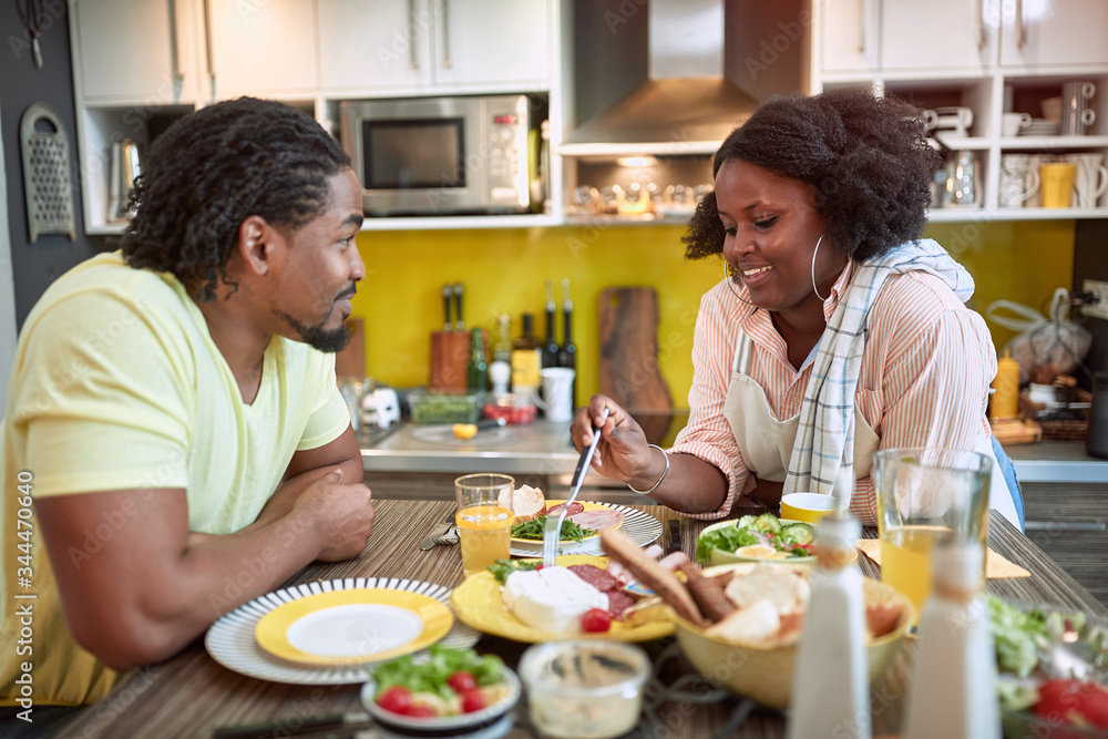 young afro-american couple enjoying breakfast together. togetherness, joy, talk, sharing meal young afro-american couple enjoying breakfast together. togetherness, joy, talk, sharing meal