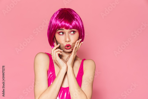 Image of young beautiful girl wearing wig talking on cellphone