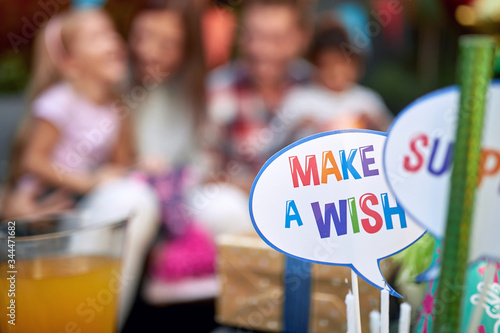 close up on a birthday cake accessory. "make a wish" sign