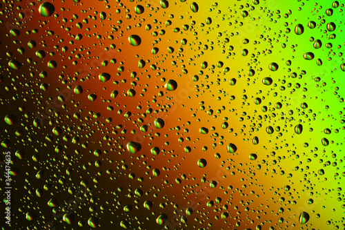 Multicolored drops on the glass