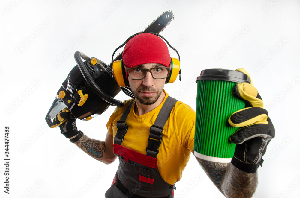Fototapeta premium a guy in protective coveralls with a chainsaw on a white background