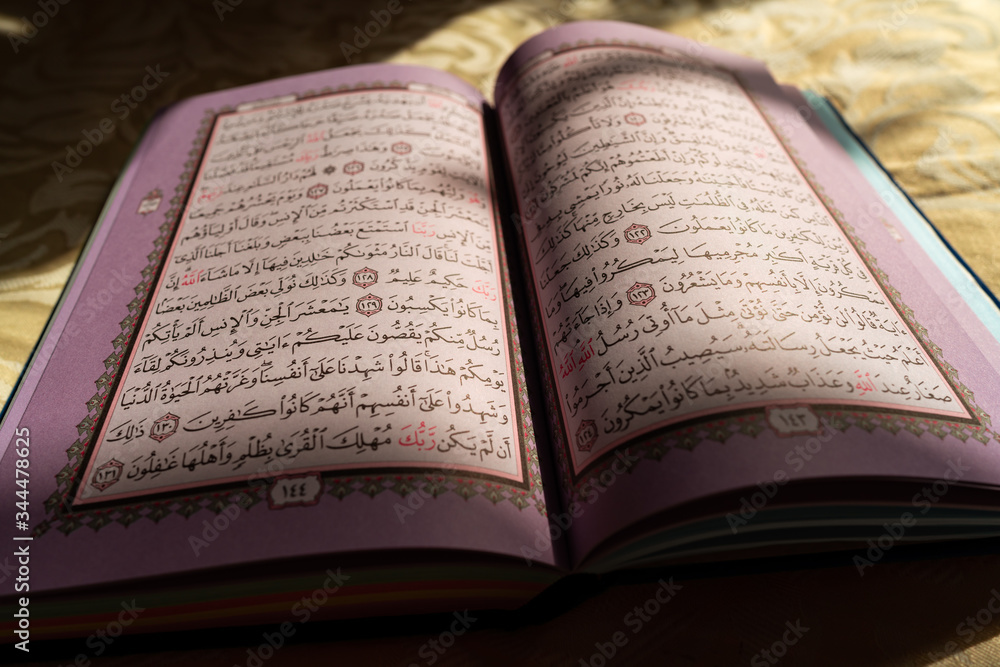 Obraz premium Colorful pages of the holy Quran book at sunset (Koran) | Islam | Ramadan Kareem and Eid Mubarak