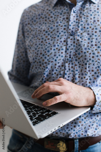 A man with a laptop in his hand. Businessman at work.