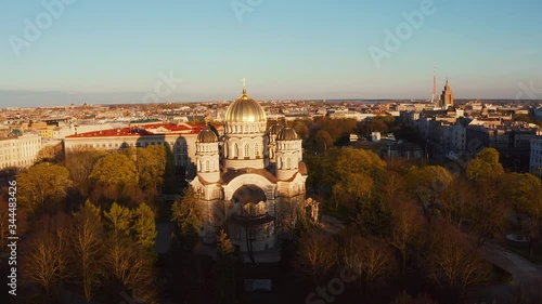 Aerial top view of Riga Nativity of Christ Cathedral - Famous Church And Landmark of Latvia. Golden Yellow Domes at sunset.  photo