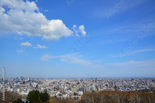 Sapporo city with blue sky and flowing clouds