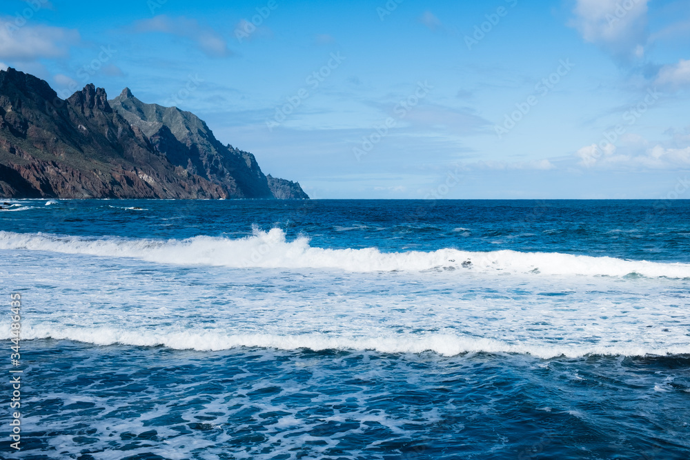 Seaside resort on Tenerife island. Ocean on a summer day, waves. Tourism and travel, vacation. Panoramic landscape. Seaside resort on Tenerife island. Ocean on a summer day, waves. Tourism and travel, vacation. Panoramic landscape.
