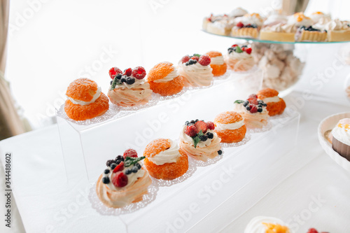 Set of eclairs decorated with berries and shugar powder