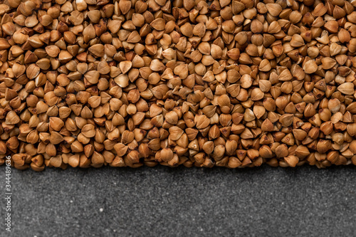 The texture of dry buckwheat. Background image of buckwheat porridge. © Alexander