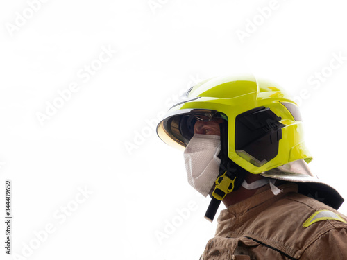 Firefighter with mask and helmet to protect himself from the covid 19