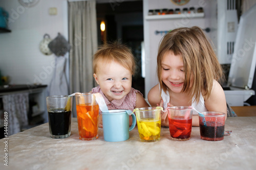 Kids experiments with color at home, mixing colors © natalialeb