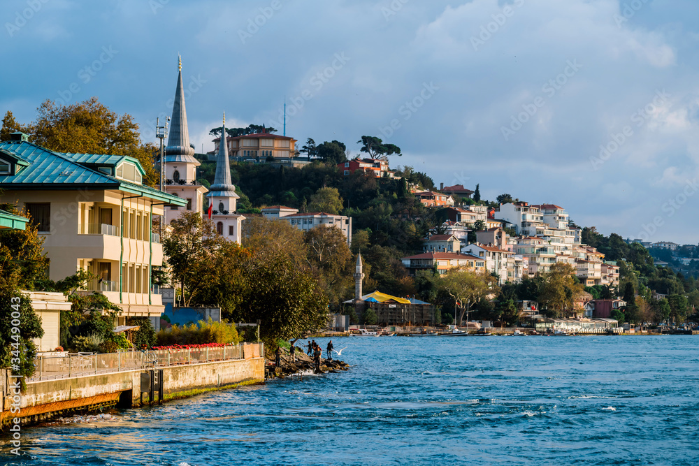 Naklejka premium Traditional and modern mansions on the Bosporus Strait waterside, Turkey Istanbul Boat trip along the Golden horn Bay in Istanbul.