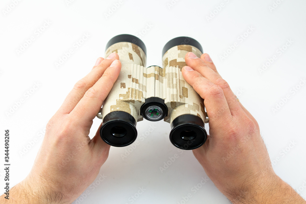 binoculars in the hands of a man binoculars in the hands of a man