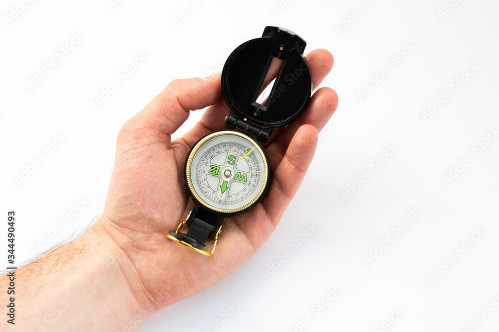 compass in hand on a white background compass in hand on a white background