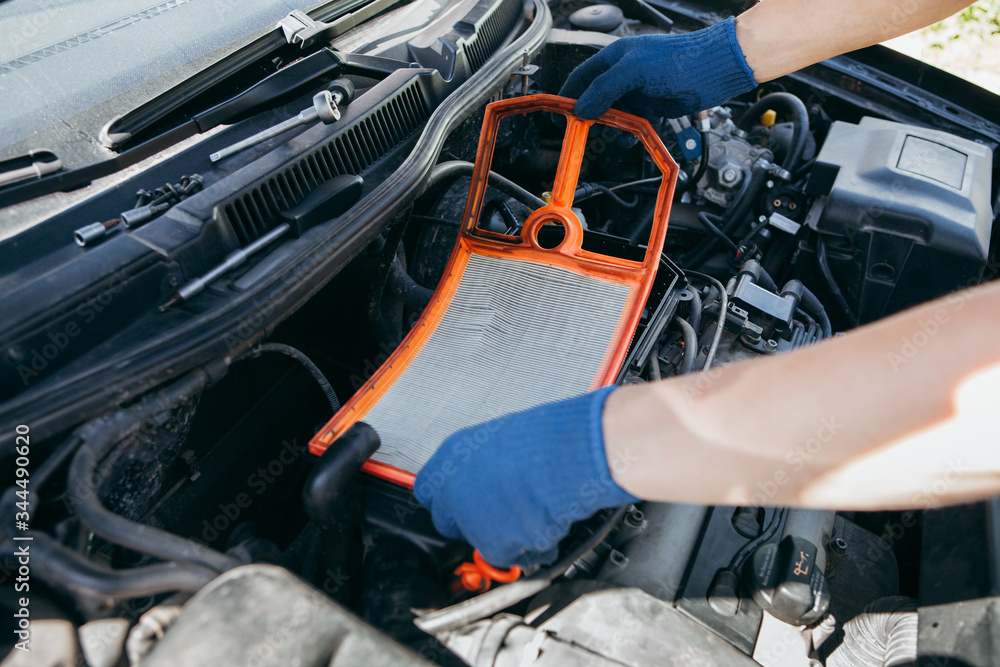 An auto mechanic repairing a car engine An auto mechanic repairing a car engine