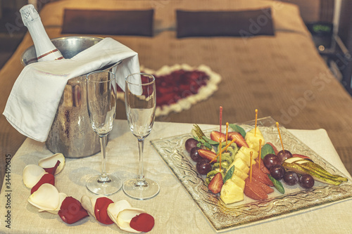 Fototapeta Naklejka Na Ścianę i Meble -  Fruit and champagne honeymoon composition for celebration