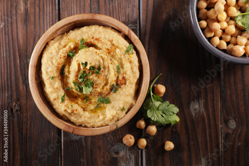 bowl of hummus on wood background