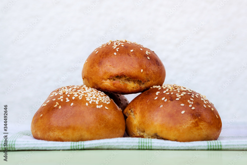 Fresh homemade burger buns with sesame seeds. Fresh homemade burger buns with sesame seeds.