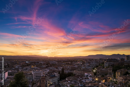 Aerial view of Granada, with a spectacular and colorful sky at sunset. © OszO