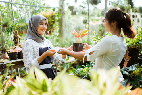 portrait of Gardener and customer on buying plants in garden