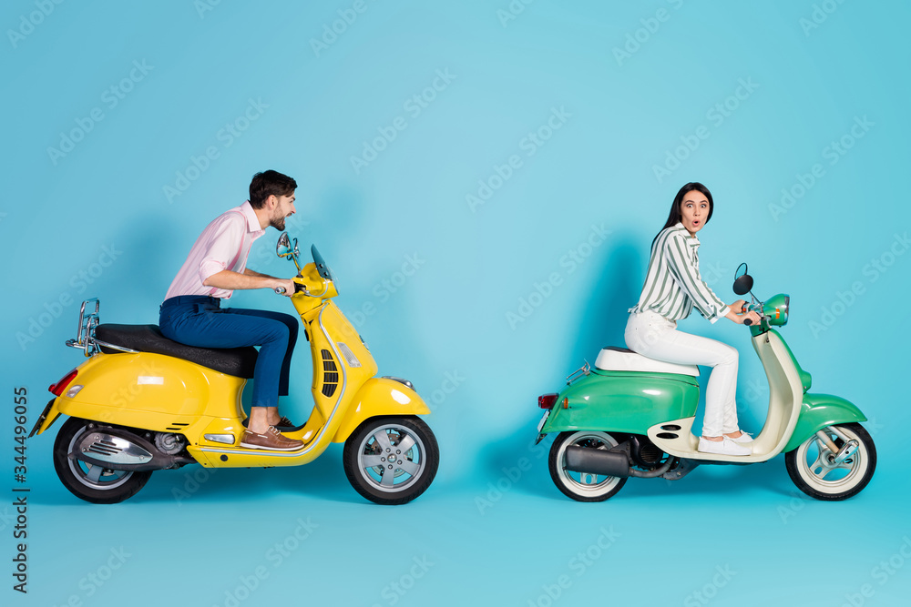 Full size profile side photo of crazy bikers wife husband drive power motor choppers woman shocked sweetheart catch her up wear white shirt pants trousers isolated over blue color background Full size profile side photo of crazy bikers wife husband drive power motor choppers woman shocked sweetheart catch her up wear white shirt pants trousers isolated over blue color background