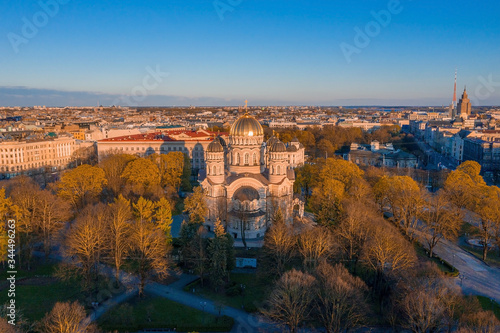 Aerial top view of Riga Nativity of Christ Cathedral - Famous Church And Landmark of Latvia. Golden Yellow Domes at sunset.  photo