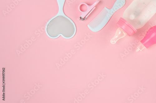 Newborn child care. Hygiene accessories, and bath set on pink background.