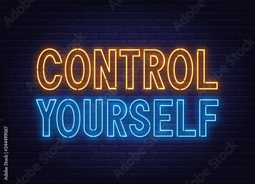 Control Yourself neon lettering on brick wall background.