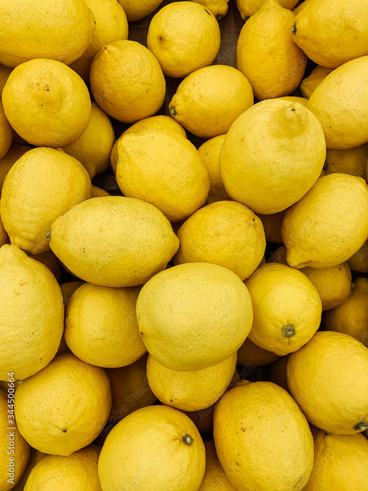 lots of ripe yellow lemons for cooking as a background lots of ripe yellow lemons for cooking as a background