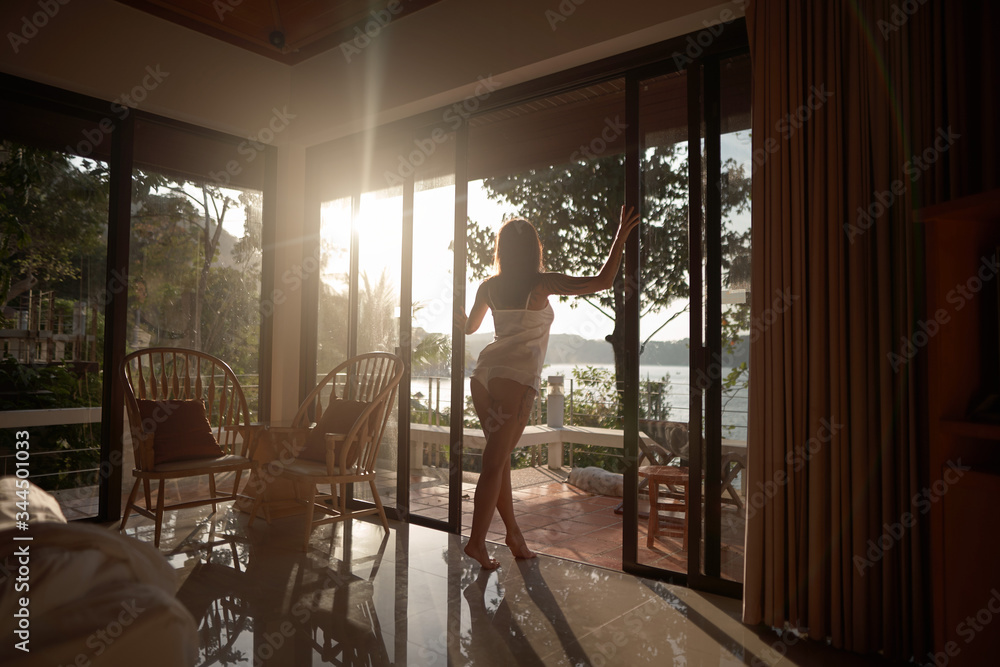 Beautiful girl looking beautiful sea view from her window in the hotel in vacation Beautiful girl looking beautiful sea view from her window in the hotel in vacation