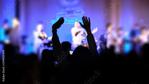 blurred, silhouette hands raising for religion background © NoonVirachada
