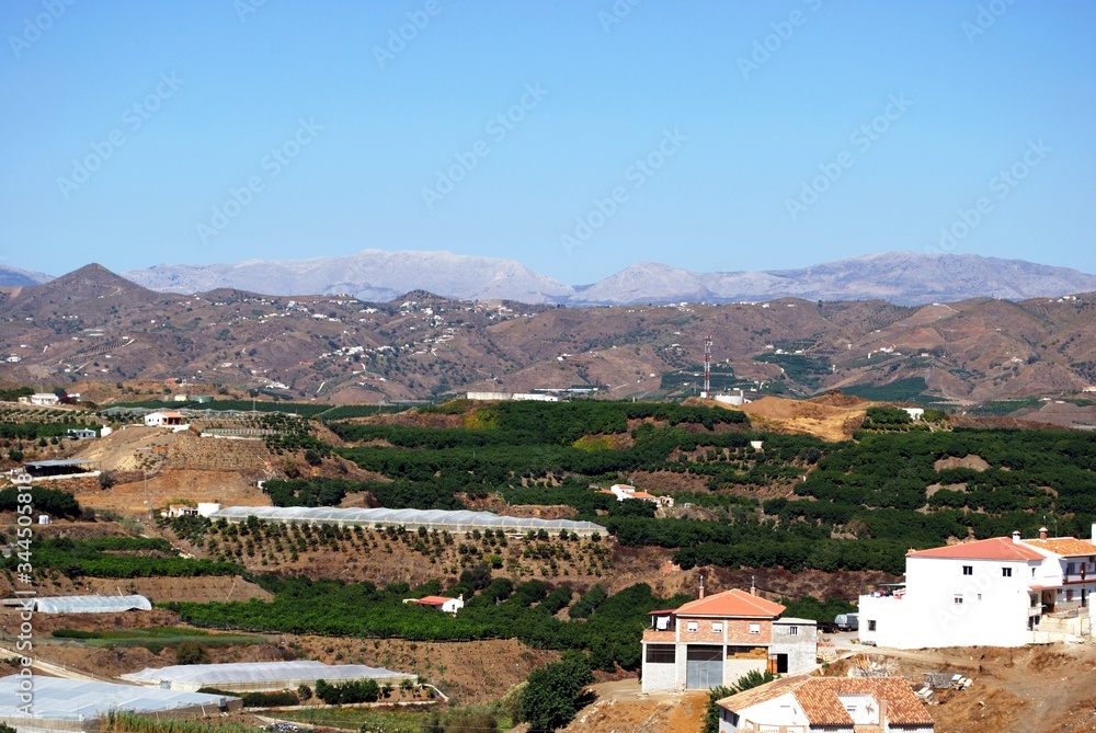 View of the countryside with mountains to the rear, Benamocarra, Andalusia, Spain.
