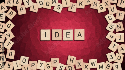 Idea written with wooden tiles over red background