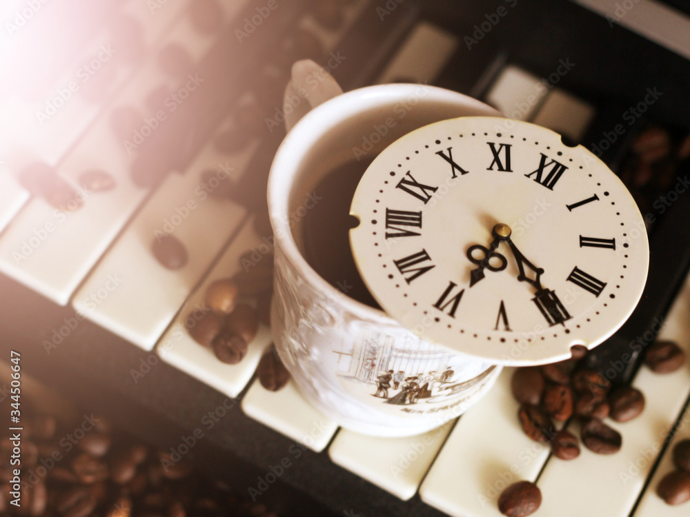 A clock with Roman numerals and a piano, coffee beans A clock with Roman numerals and a piano, coffee beans