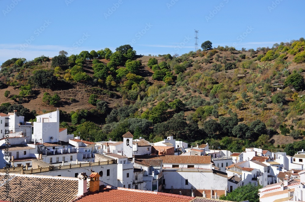 View of whitewashed village with mountains to the rear, Igualeja, Andalusia, Spain.