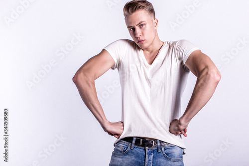 Sexy smiling male model against white background