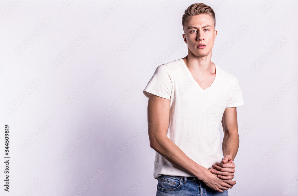 Fototapeta premium Sexy smiling male model against white background