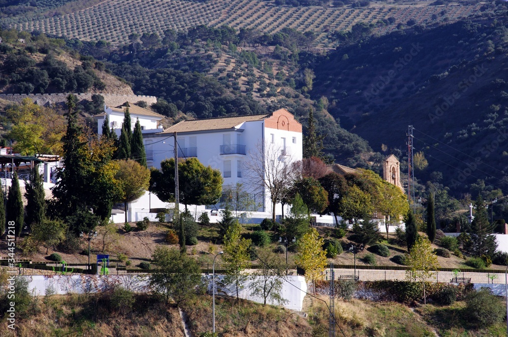View of the whitewashed convent with mountains to the rear on the edge of a whitewashed village (pueblo blanco), Algarinejo, Andalusia, Spain.